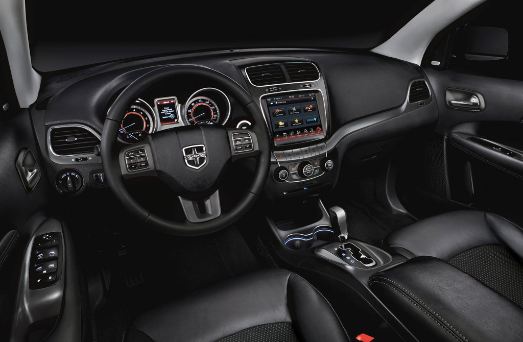 A large, 8.4-inch touchscreen dominates the center stack in the Journey Crossroad Plus models.