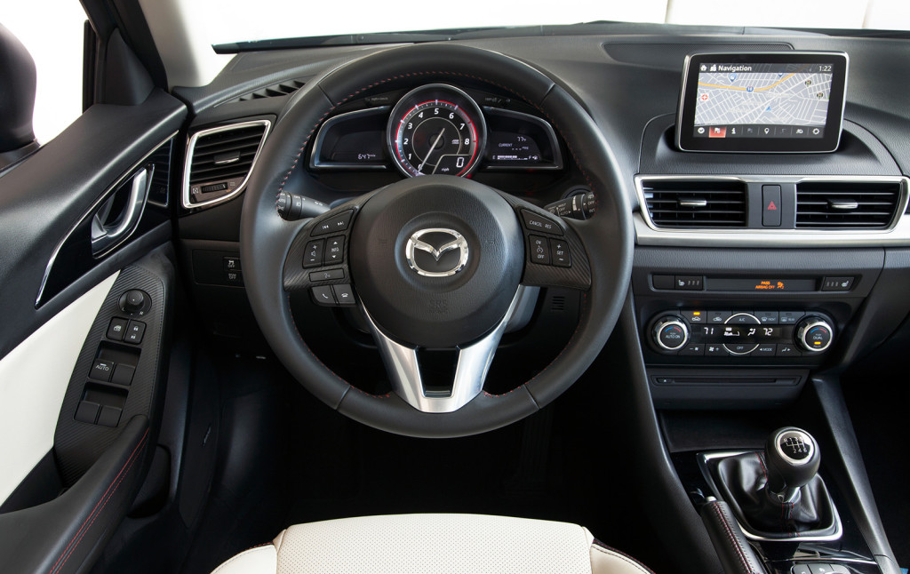 A tachometer dominates the instrument cluster in the driver-focused Mazda3. A digital display mounted high on the dash help’s keep the driver’s eyes on the road.